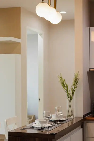 Modern kitchen with elegant lighting and dining setup