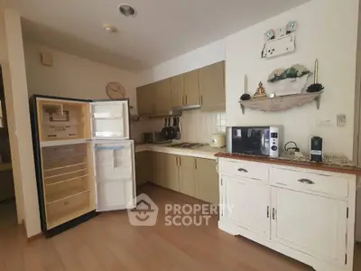 Charming kitchen with open fridge and modern appliances in cozy apartment