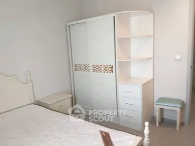 Cozy bedroom with elegant white furniture and ample storage space