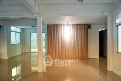 Spacious modern interior with glossy floors and wooden accent wall