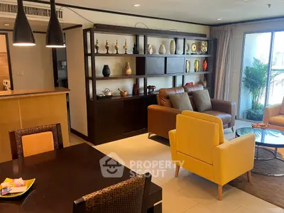 Stylish living room with modern decor and open layout, featuring cozy seating and elegant shelving.