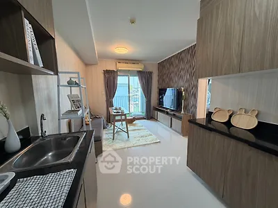 Modern living room with open kitchen, stylish decor, and balcony view in a contemporary apartment.
