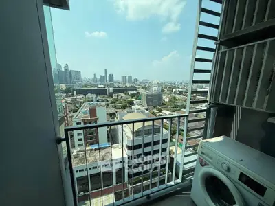 Stunning city view from high-rise balcony with washing machine