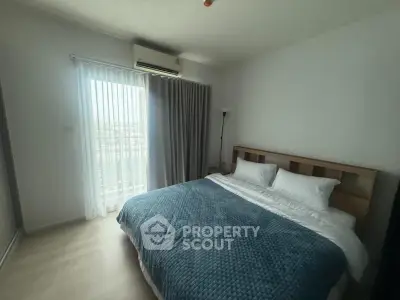 Cozy bedroom with large bed and natural light from window, perfect for relaxation.