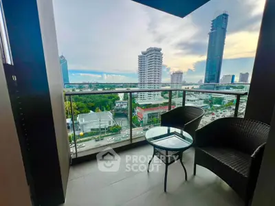 Stunning city view from a modern balcony with stylish seating, perfect for relaxation.