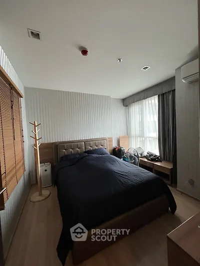 Cozy bedroom with modern decor and ample natural light