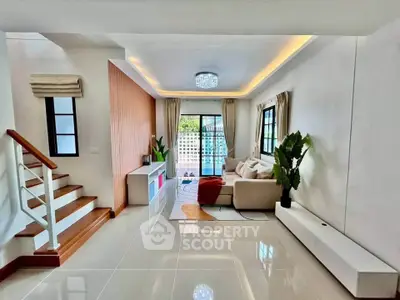 Spacious modern living room with elegant decor and large windows offering natural light.