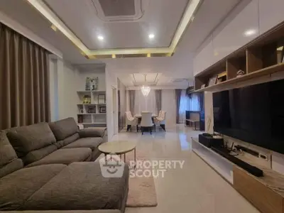 Spacious modern living room with elegant dining area and cozy seating.
