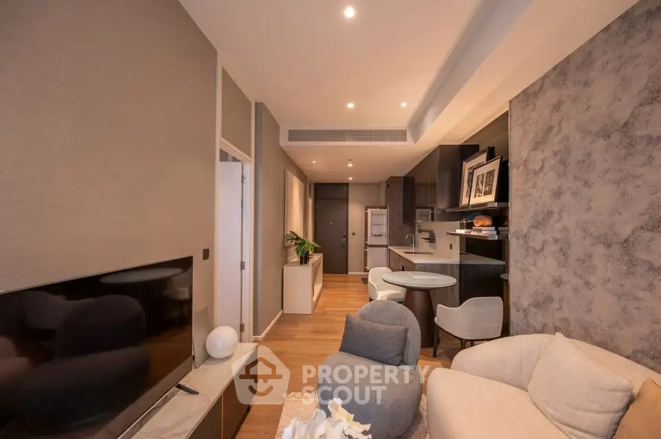 Modern living room with open kitchen, stylish decor, and cozy seating area in a contemporary apartment.