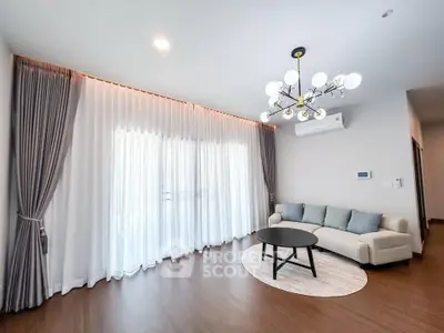Spacious modern living room with elegant lighting and large windows