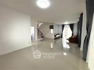 Spacious modern living room with glossy floors and elegant curtains