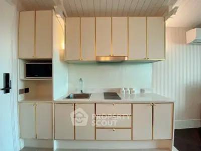 Modern kitchen with sleek cabinetry and built-in appliances