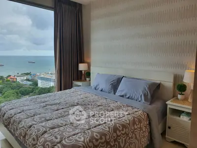 Luxurious bedroom with ocean view, elegant decor, and large window in a high-rise apartment.
