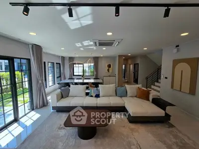 Spacious modern living room with large windows and stylish decor