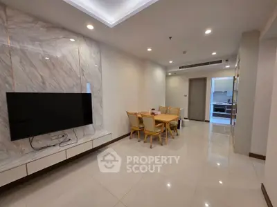 Spacious modern living room with elegant dining area and wall-mounted TV