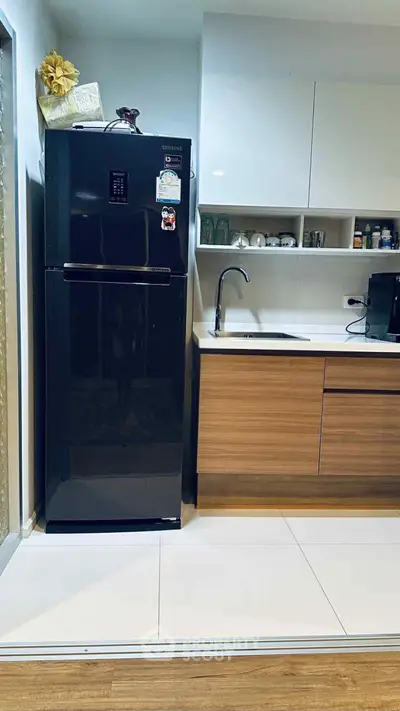 Modern kitchen with sleek black fridge and stylish wooden cabinetry