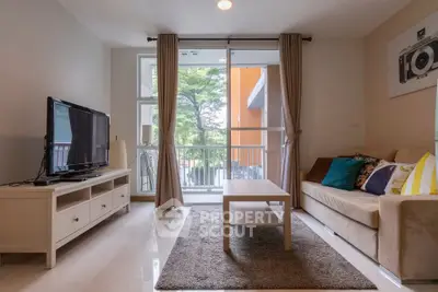 Modern living room with balcony view, cozy sofa, and stylish decor in a bright apartment.