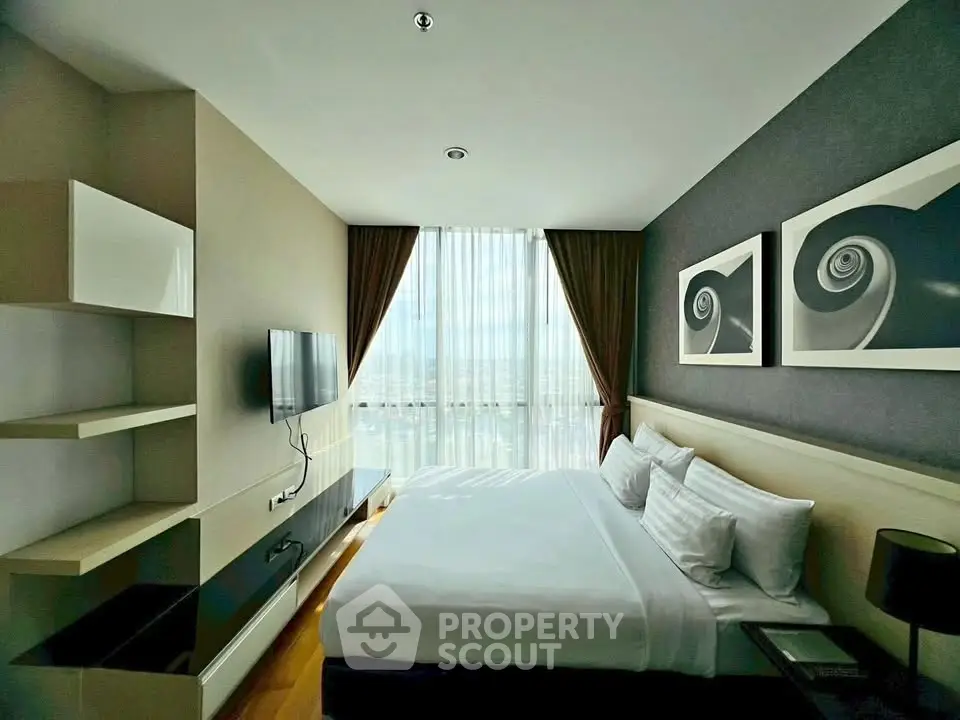 Modern bedroom with large window and stylish decor in a high-rise apartment.