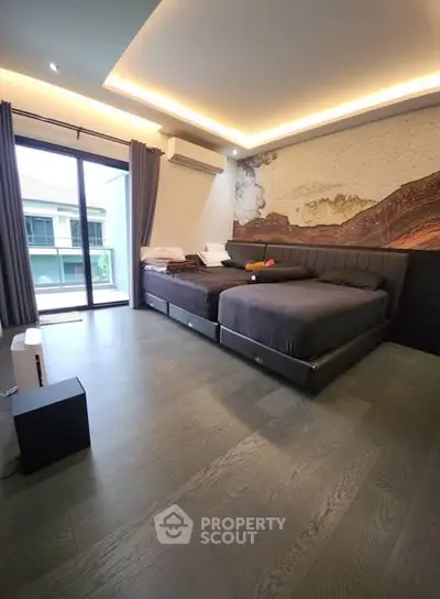 Spacious modern bedroom with large windows and stylish decor