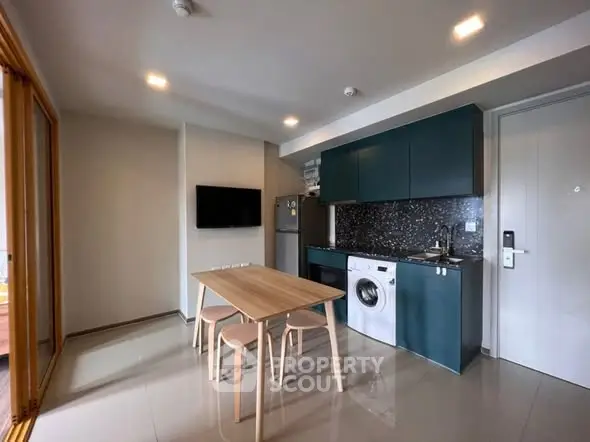 Modern kitchen with sleek cabinetry and integrated appliances in stylish apartment.
