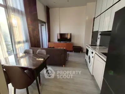 Modern living room with stylish furniture and in-unit washing machine, perfect for urban living.