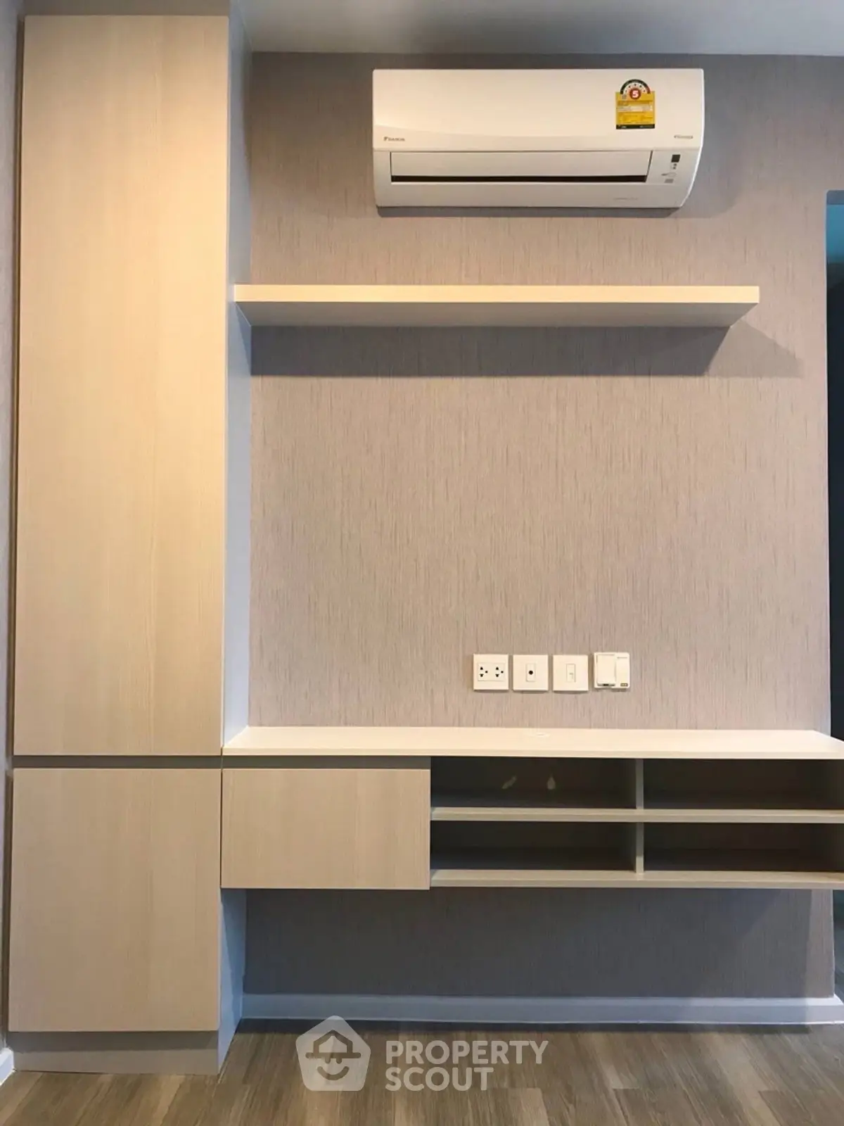 Modern interior wall with built-in shelving and air conditioning unit, perfect for stylish living room setup.