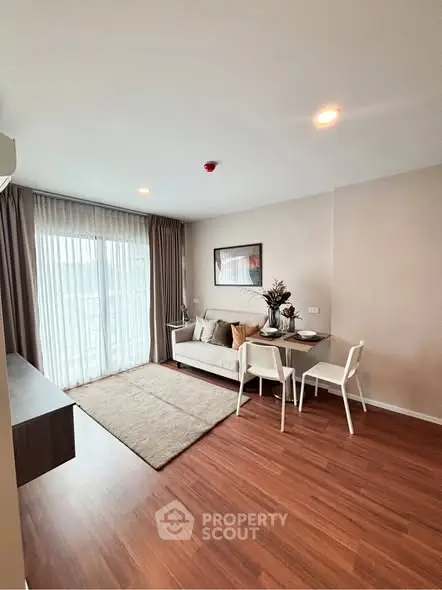 Modern living room with wooden flooring and cozy seating area