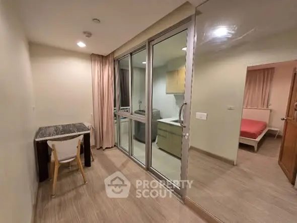 Modern apartment interior with glass partition and cozy dining area