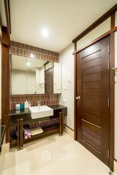 Modern bathroom with stylish wooden accents and sleek sink design