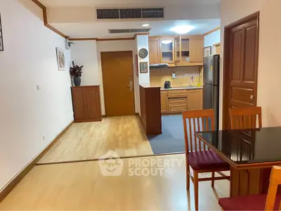 Spacious open-plan kitchen and dining area with wooden flooring and modern appliances.