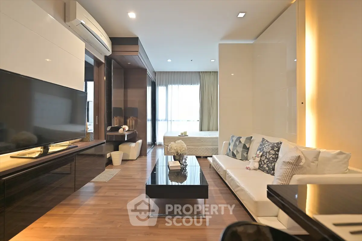 Modern open-plan living room with elegant decor and natural light