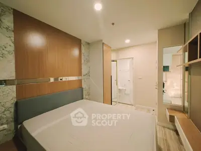 Modern bedroom with stylish wood paneling and ensuite bathroom