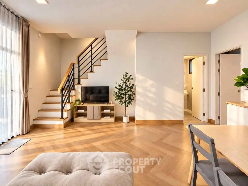 Spacious modern living room with elegant staircase and natural light