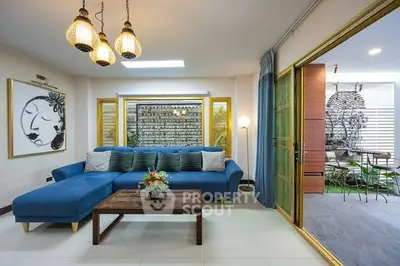 Spacious living room with modern decor and large sliding doors to outdoor patio.