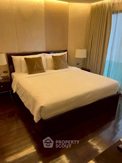 Luxurious bedroom with elegant decor and plush bedding in a modern apartment.