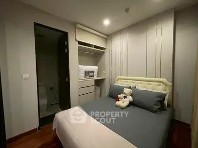 Cozy bedroom with modern decor and plush bedding, perfect for relaxation and comfort.