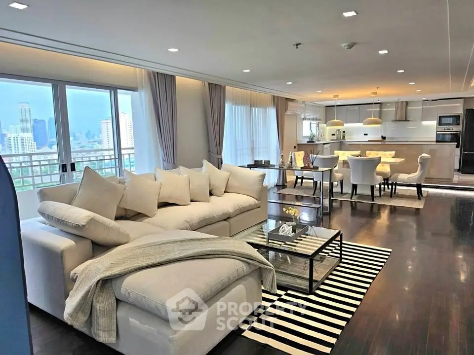 Luxurious open-plan living room with stunning city views and modern kitchen.