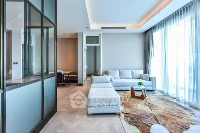 Luxurious modern living room with elegant furniture and large windows offering abundant natural light.