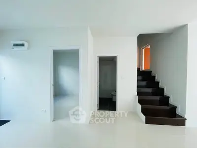 Modern minimalist interior with staircase and white walls