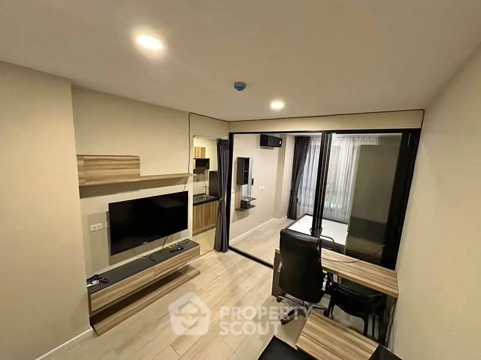 Modern living room with sleek furniture and large mirror enhancing space