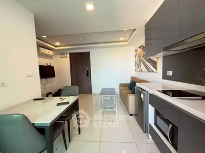 Modern living room with sleek kitchen in open layout, featuring stylish furniture and contemporary design.