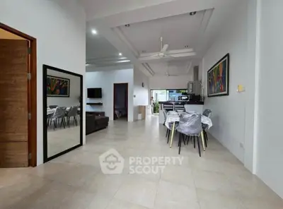 Spacious open-plan living and dining area with modern decor and natural light.
