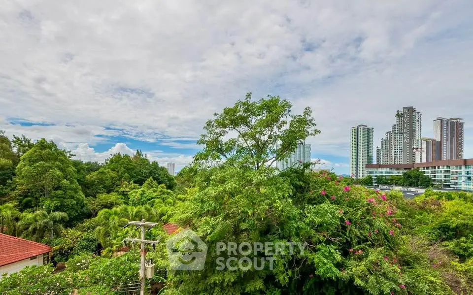 Stunning cityscape view with lush greenery and modern high-rise buildings.