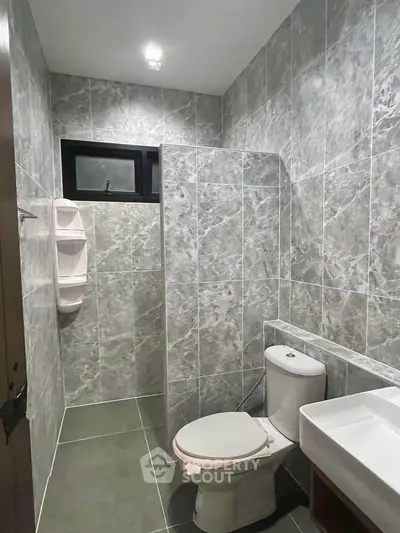 Modern bathroom with sleek gray tiles and contemporary fixtures