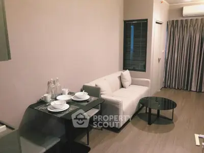 Modern living room with cozy sofa, dining table, and stylish decor in a contemporary apartment.