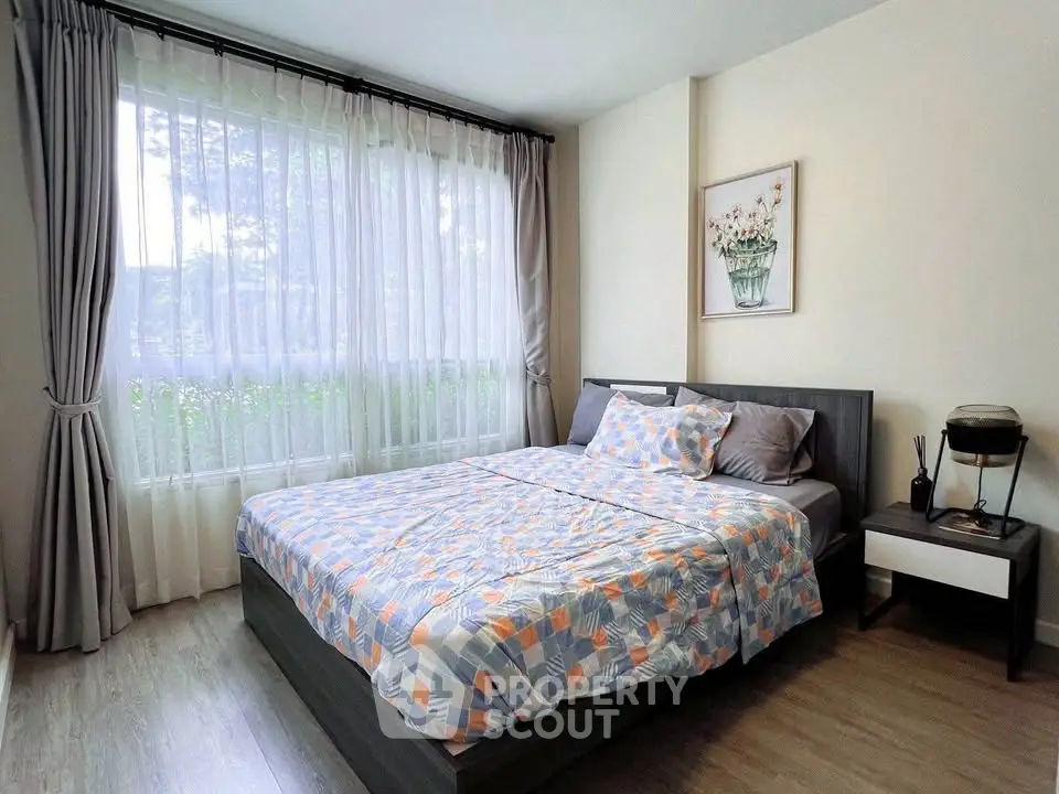 Cozy bedroom with large window and modern decor