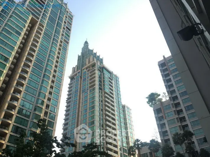 Stunning high-rise buildings with modern architecture and lush greenery in urban setting.