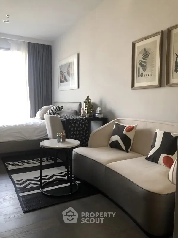 Stylish modern living room with cozy seating and elegant decor in a bright apartment.