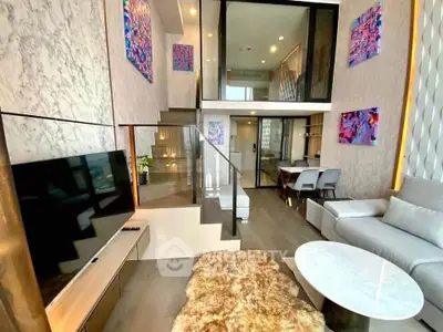 Luxurious modern living room with high ceilings, stylish decor, and open layout in a duplex apartment.