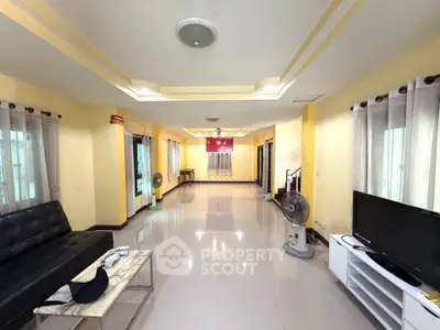 Spacious living room with modern furnishings and ample natural light.
